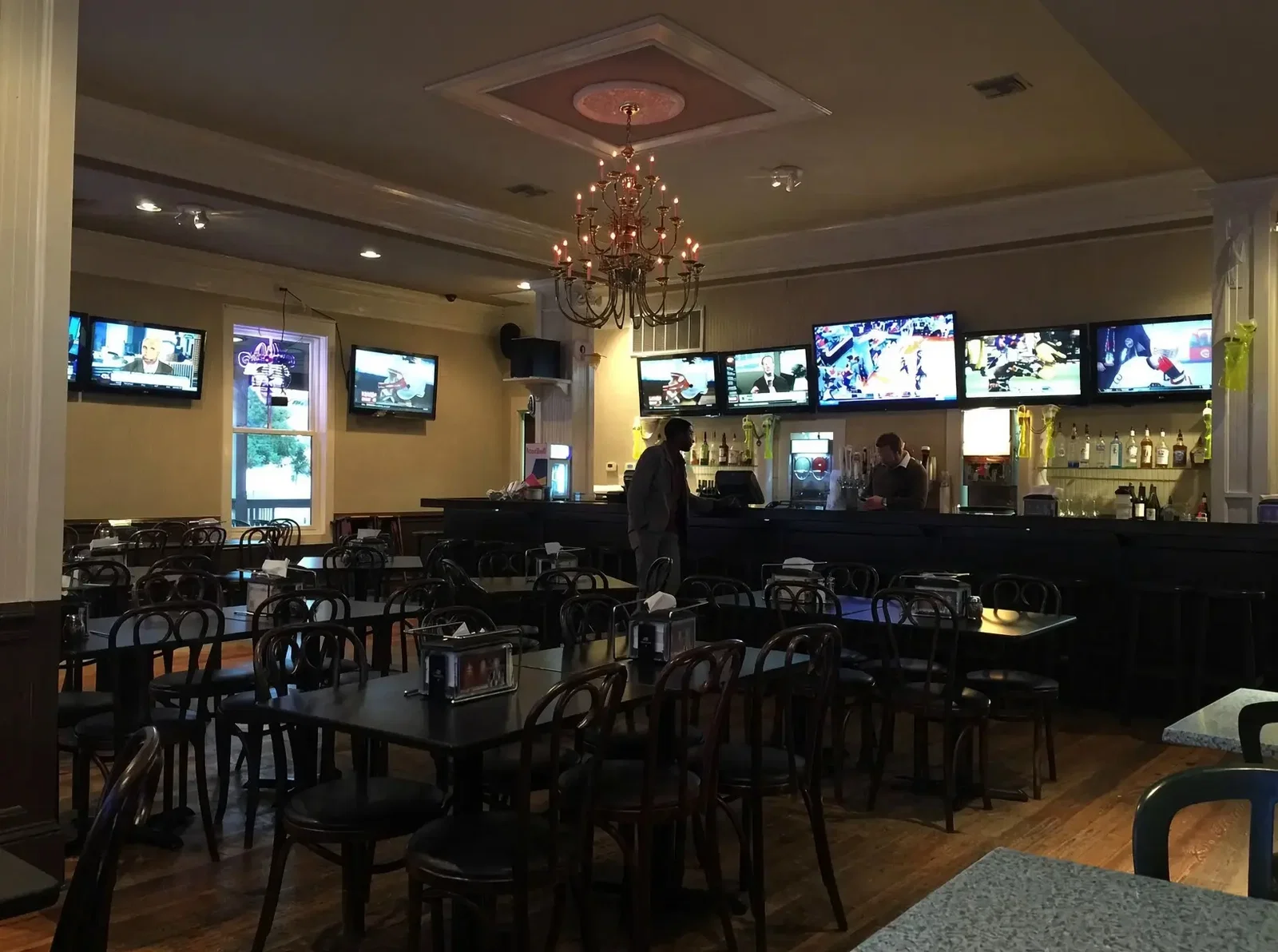 The bar and dining room at Roberto's Pizzeria Sports Bar & Grill at the Village of Baytowne Wharf in Sandestin, with TVs running the length of the bar